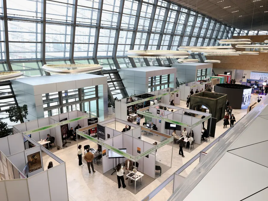 An exhibition hall with rows of booths
