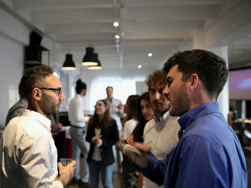 Two people in conversation at a busy event