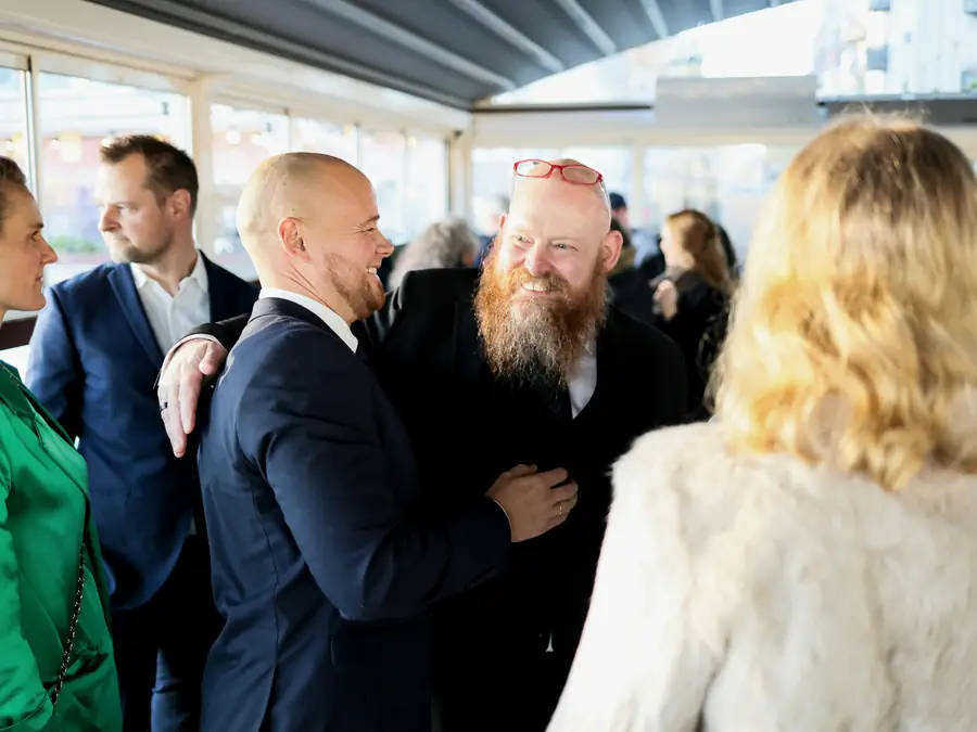 Attendees greeting each other at an evening reception