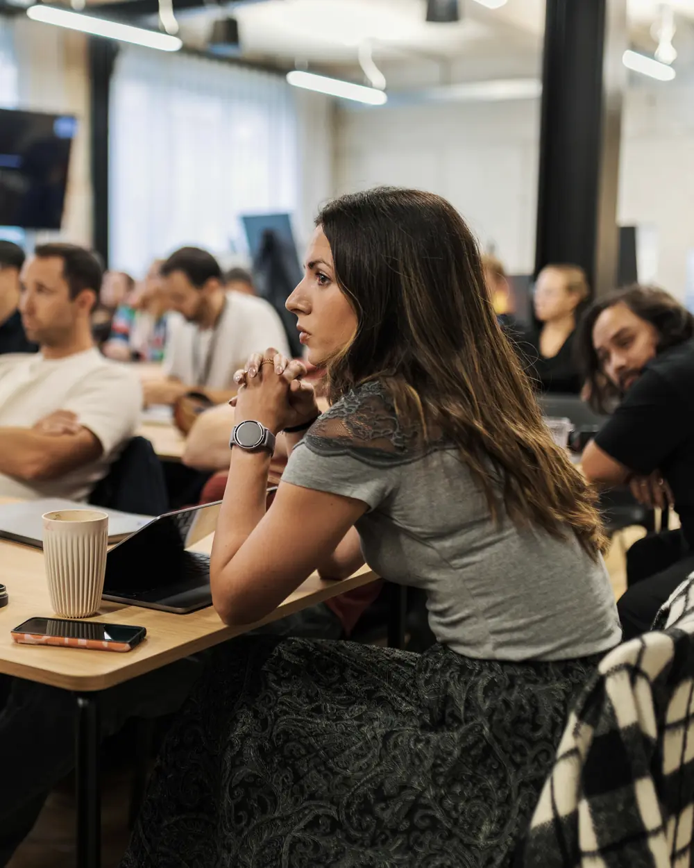 Attendees seated at tables in a workshop session