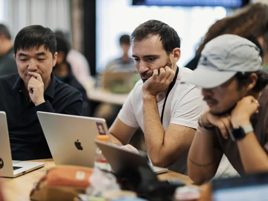 Developers working together on laptops